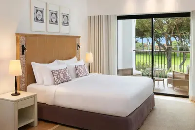 a hotel room with a bed and a television at Pine Cliffs Ocean Suites, a Luxury Collection Resort & Spa, Algarve in Albufeira