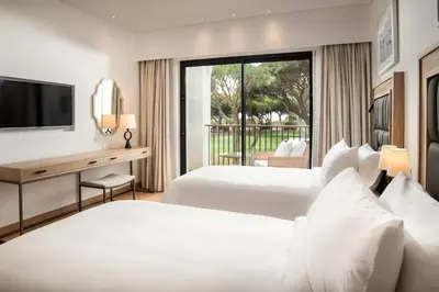 a bathroom with a sink and a tub and a mirror at Pine Cliffs Ocean Suites, a Luxury Collection Resort & Spa, Algarve in Albufeira