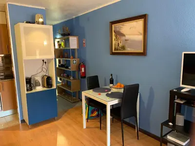a dining room with a table and a blue wall at Forte Apartment in Albufeira