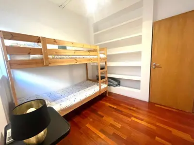 a room with two bunk beds and a door at Vila D'Alba - Sem Stress in Albufeira