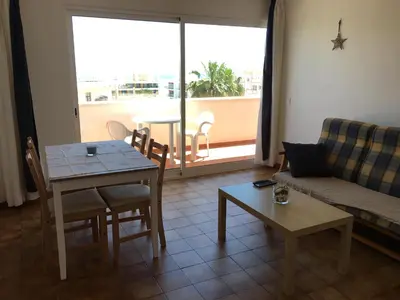 a living room with a couch and a table at Vila Praia Apartment in Albufeira