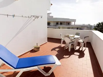 a bathroom with a white toilet and a sink at Vila Praia Apartment in Albufeira