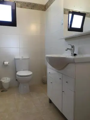 a bathroom with a toilet and a sink and a shower at Vila Praia Apartment in Albufeira