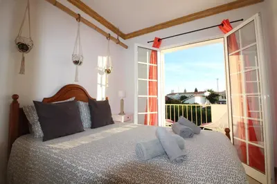 a bedroom with a large bed with a large window at Villa Summertime - Private Jacuzzi and bikes, beach 800m in Albufeira