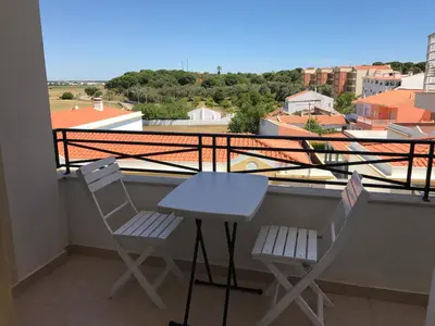 two chairs and a table on a balcony with a view at Albufeira Falesia Beach Apartment in Albufeira