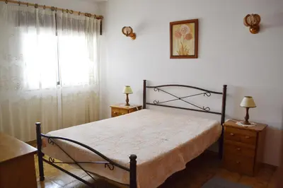 a bedroom with a bed and a window at Vista Mar Apartamento in Albufeira