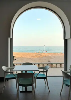 a table and chairs with a view of the beach at INATEL Albufeira in Albufeira