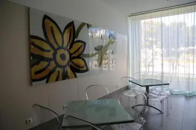 a dining room with a glass table and chairs at INATEL Albufeira in Albufeira