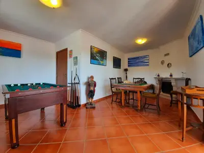 a room with a pool table and a dining room at Villa Quinta do Algarve in Albufeira