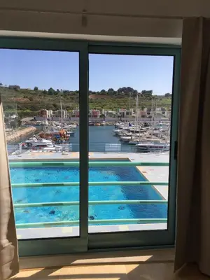 a view of a swimming pool through a window at Apartment Orada Marina in Albufeira