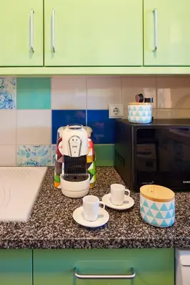 a kitchen counter with two cups and a coffee maker at Apartment Orada Marina in Albufeira