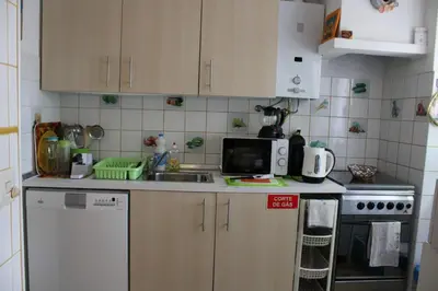 a small kitchen with a sink and a stove at Casa Portuguesa in Albufeira