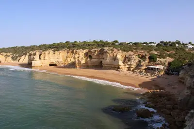 a beach with a bunch of chairs on the sand at Casa Portuguesa in Albufeira