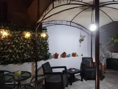 a room with a table and chairs and an umbrella at The Sunny Cottage by Freetimealgarve in Faro