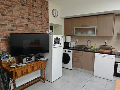 a kitchen with a white refrigerator and a microwave at The Sunny Cottage by Freetimealgarve in Faro