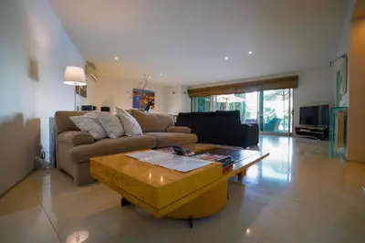 a living room with a couch and a coffee table at Villa Laguna Golf-Frente ao laguna Golf in Vilamoura