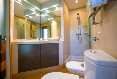 a bathroom with a toilet and a sink and a shower at Villa Laguna Golf-Frente ao laguna Golf in Vilamoura