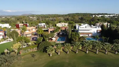 an aerial view of a mansion with palm trees at Villa Laguna Golf-Frente ao laguna Golf in Vilamoura