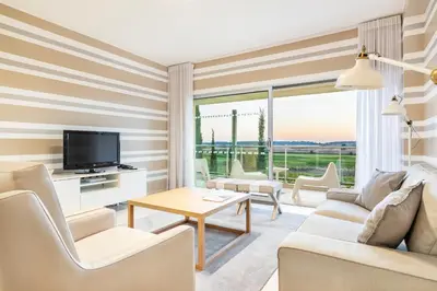 a living room with a couch and a tv and a table at Laguna - Vilamoura in Vilamoura
