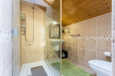 a bathroom with a shower and a toilet and a sink at MariaHouse in Faro
