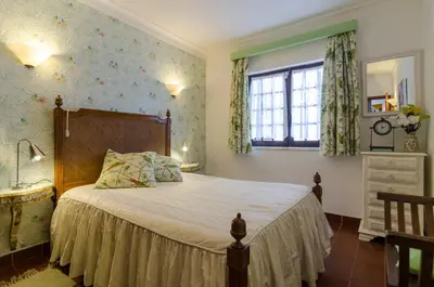 a bedroom with a bed and a window at Villa Casa do Sul in Albufeira