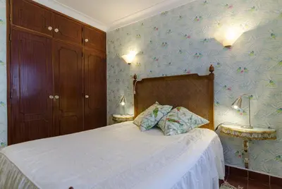 a bedroom with a bed with a white bedspread at Villa Casa do Sul in Albufeira