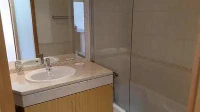 a bathroom with a sink and a shower and a tub at Vista das Ondas Apartamento 205 B2 - Olhos de Agua in Albufeira
