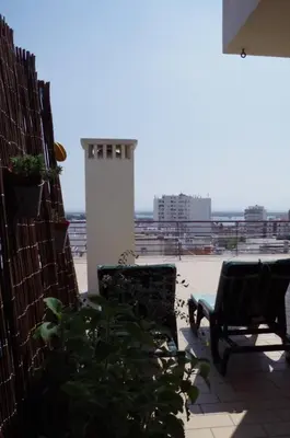 two chairs on a patio with a view of a city at BellaVita City Faro in Faro