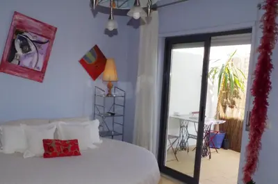 a bedroom with a bed and a sliding glass door at BellaVita City Faro in Faro