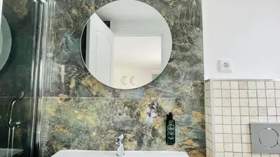 a bathroom with a mirror and a sink at Strip by Check-in Portugal in Albufeira