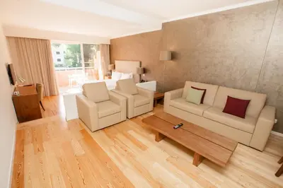 a living room with two chairs and a coffee table at Vilamoura Garden Hotel in Vilamoura