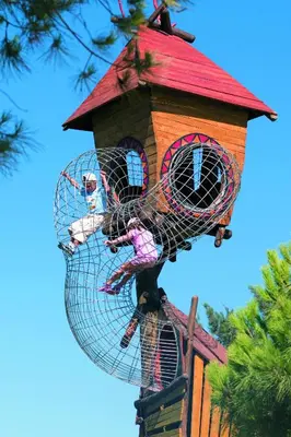 a bird house with two birds on top of it at Vilamoura Garden Hotel in Vilamoura