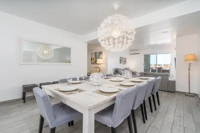 a dining room with a large table and chairs at Marina Vilamoura Triplex in Vilamoura