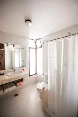 a bathroom with a shower and a toilet and a sink at Apartamentos Tio Papel in Albufeira