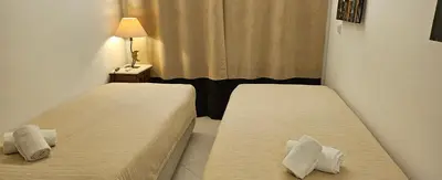two beds in a small room with a window at Golf & Mar - T2 Apartment in Vilamoura