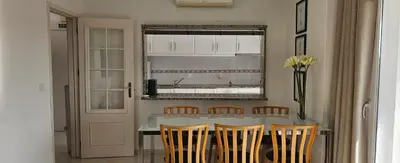 a kitchen with a table with chairs and a window at Golf & Mar - T2 Apartment in Vilamoura