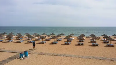 a bunch of chairs and umbrellas on a beach at Studio near the beach in Albufeira