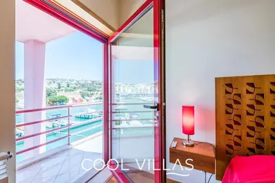 a bedroom with a view of a balcony at Villa AcquaMarina - 5 bedroom, water front villa in Albufeira