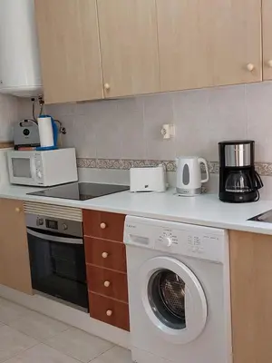a kitchen with a washing machine on a counter at Apartamento Sunny Velamar in Patroves
