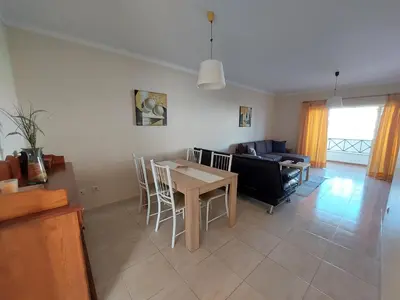 a living room with a table and a couch at Apartamento Sunny Velamar in Patroves