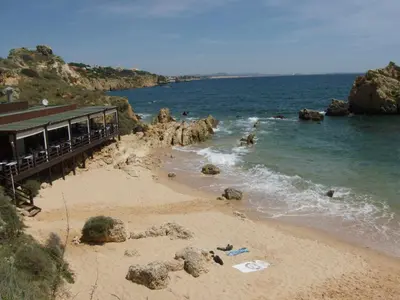 a beach with a pier next to the ocean at Apartamento Sunny Velamar in Patroves