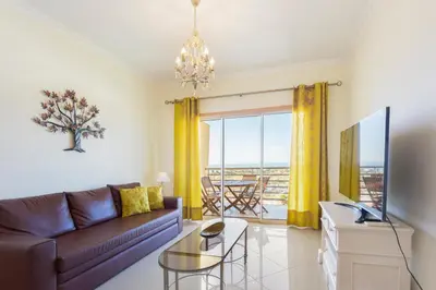 a living room with a couch and a table at Encosta Da Orada by Garvetur in Albufeira