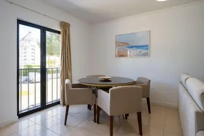 a white bathroom with a sink and a shower at Mouraliz Apartments by HD PROPERTIES - Vilamoura Marina in Vilamoura