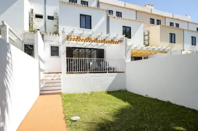 a kitchen with white cabinets and a sink at Mouraliz Apartments by HD PROPERTIES - Vilamoura Marina in Vilamoura