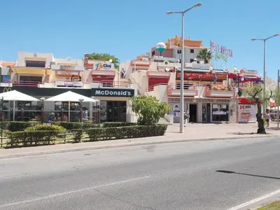 a street with a building on the side of a road at Bellavista Apartments in Albufeira