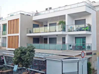 an apartment building with balconies and a parking lot at Apartamento Olhos D'Água in Albufeira