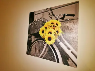 a picture of a bike with yellow flowers on it at Apartamento Penha T3 in Faro