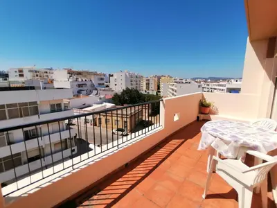 a balcony with a table and a view of the city at Apartamento Penha T3 in Faro