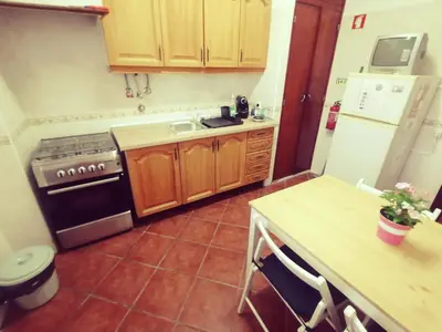 a kitchen with a stove and a sink in it at Apartamento S. Luis in Faro