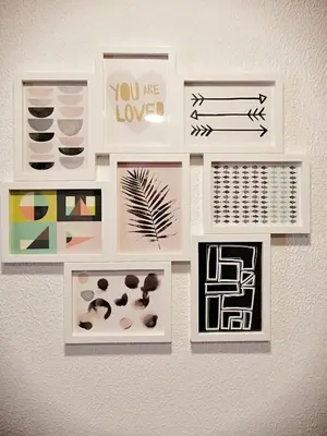 a wall with framed pictures on a wall at Apartamento Penha in Faro